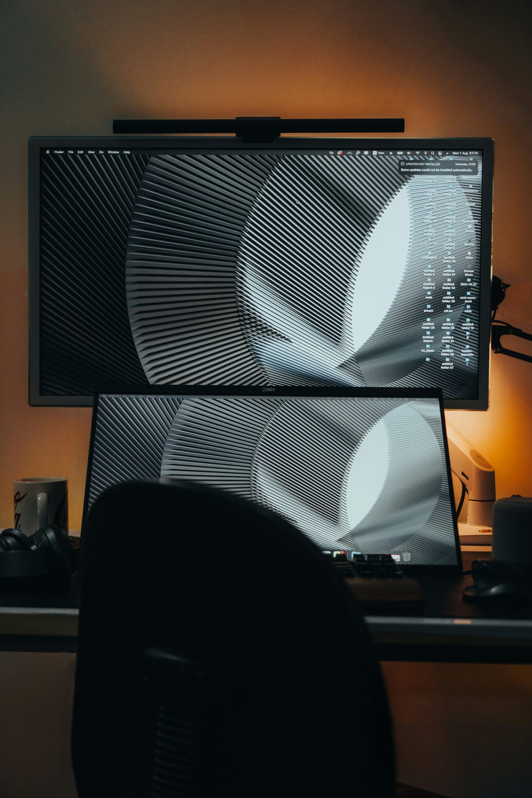 Designer working on UI mockups on a large monitor showing color palettes and typography choices.