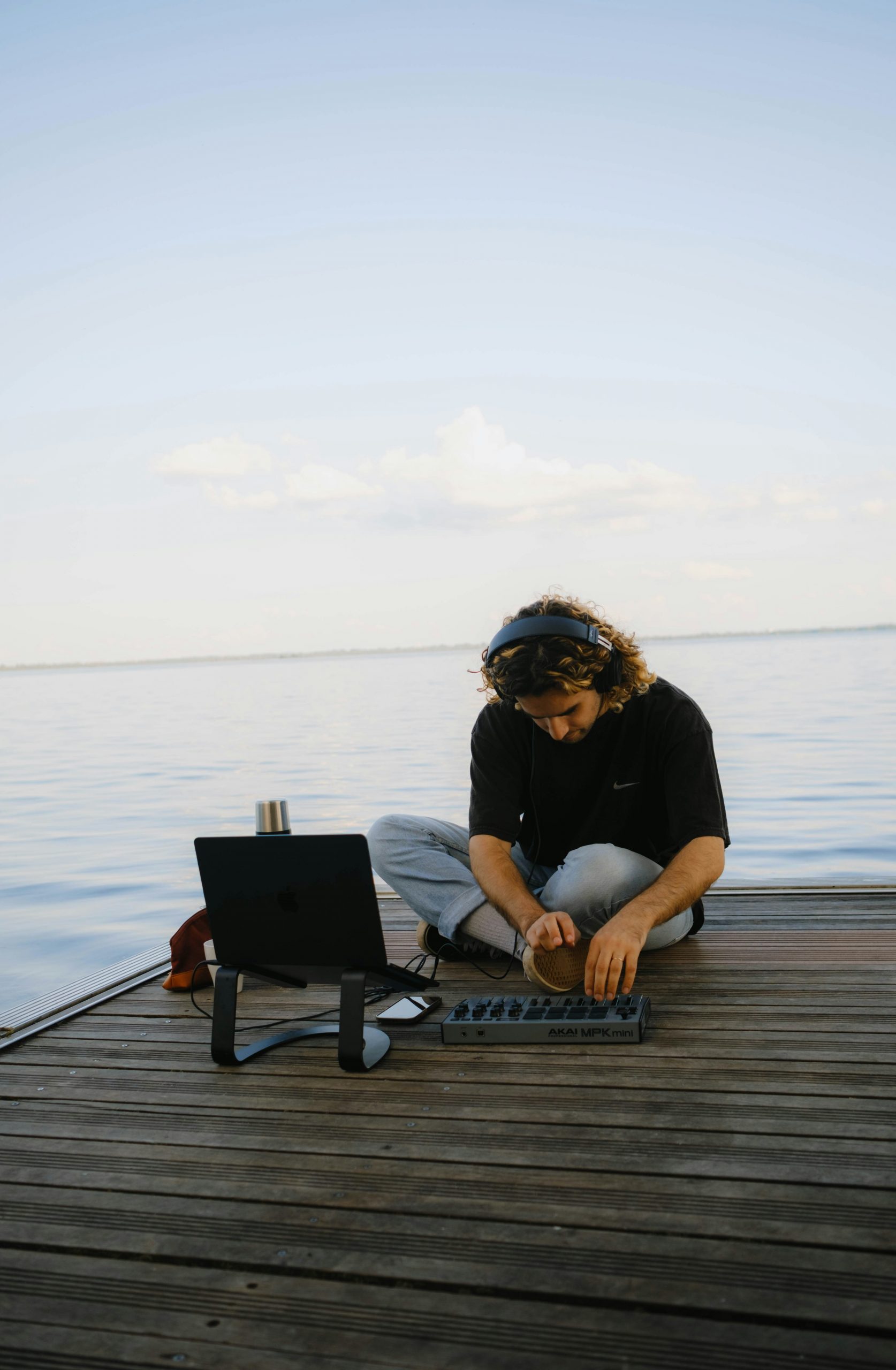 Male developer working on code maintenance on laptop in a modern office setup