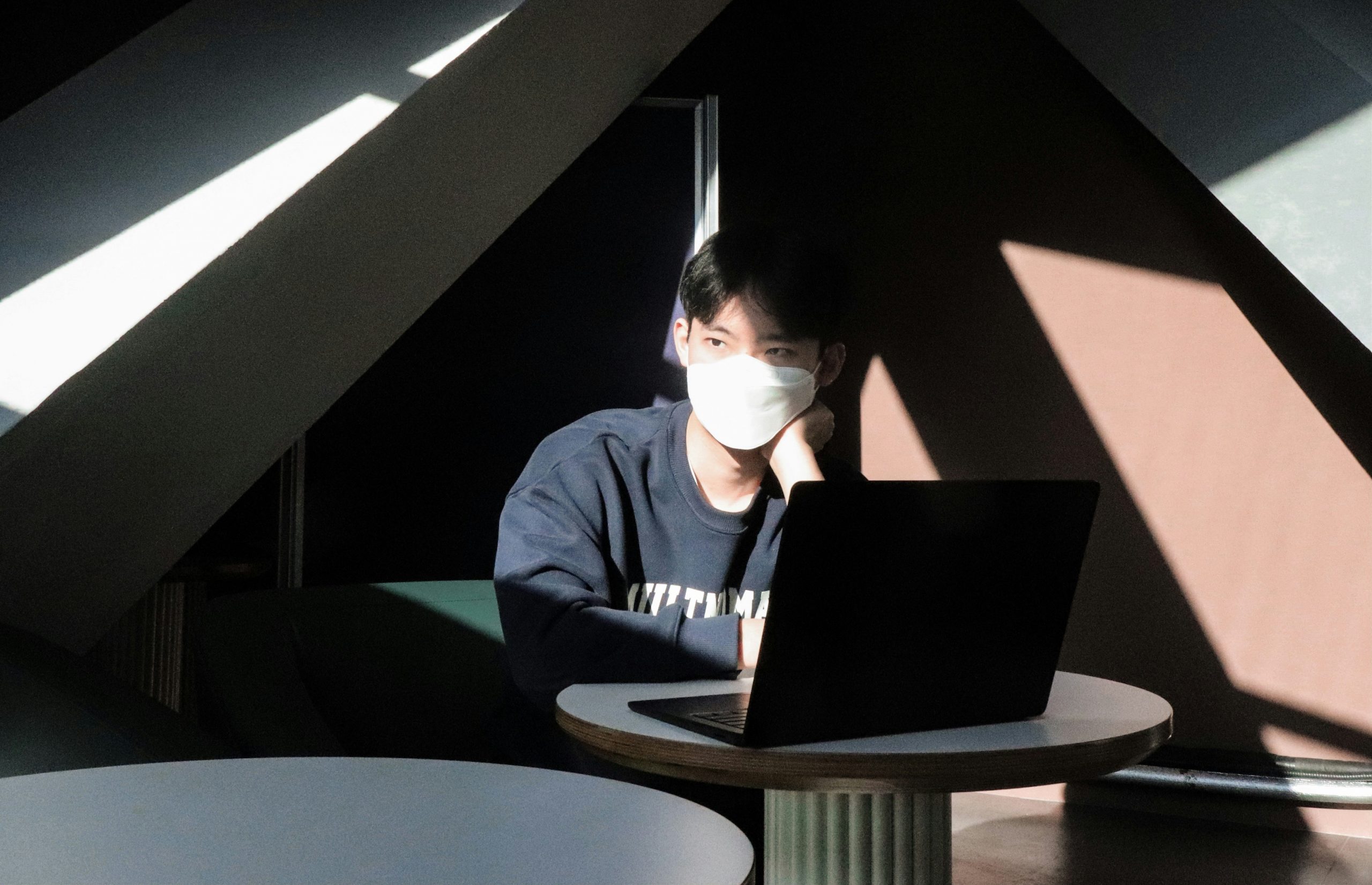 Close up of a person working on code and ux design on a laptop in a cafe