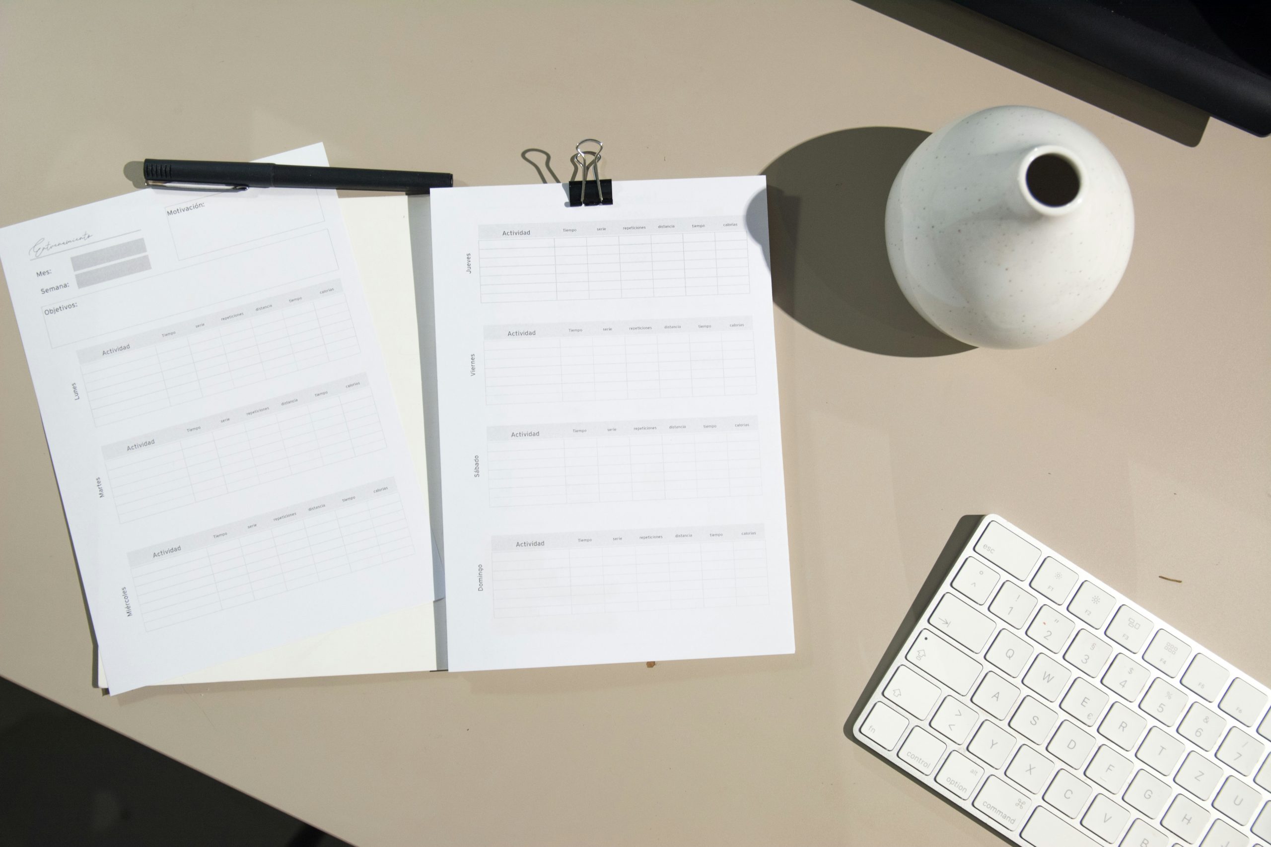Close up of a hand checking point on a paper checklist checklist on a desk with a laptop