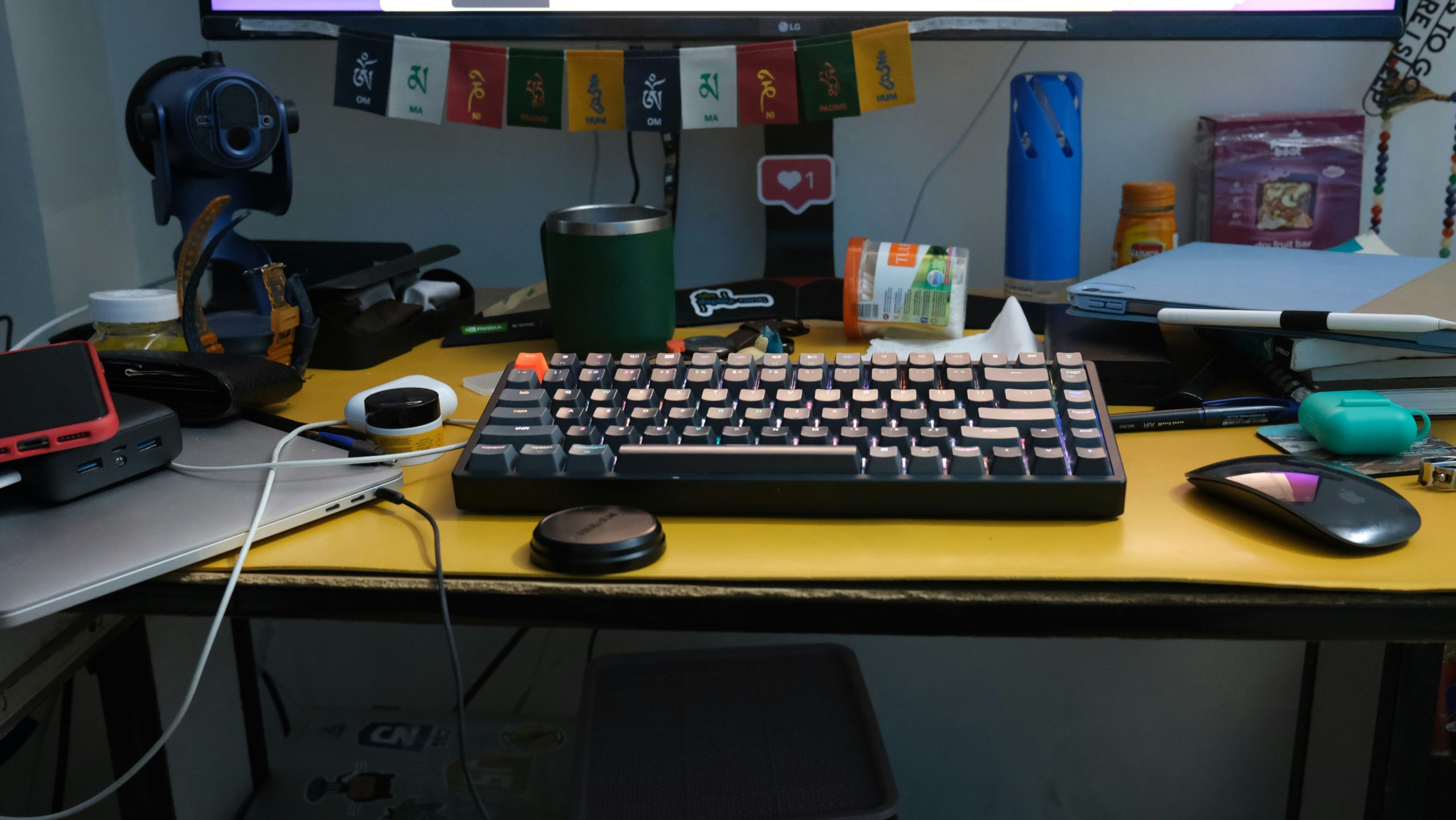 Close-up of a hand typing on a laptop keyboard with a blurred background of a creative open space office