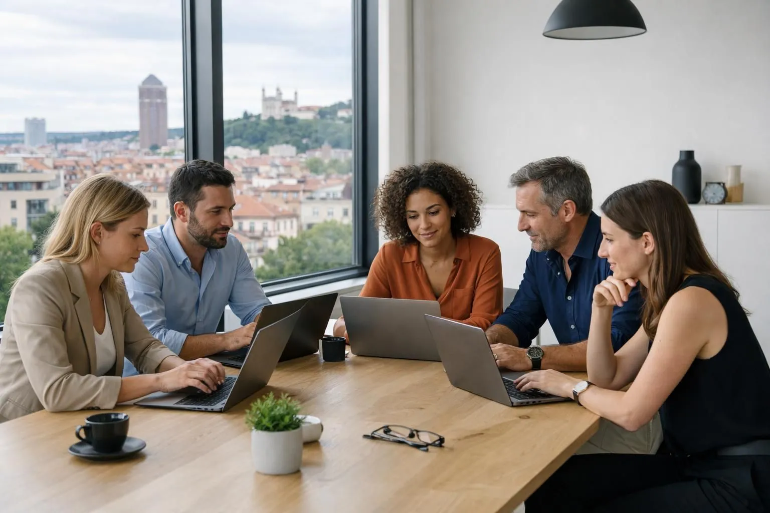 Business professionals examining multiple agency proposals on laptops around a conference table in modern Lyon office, with visible project timelines and budget comparisons on screens, natural lighting through large windows