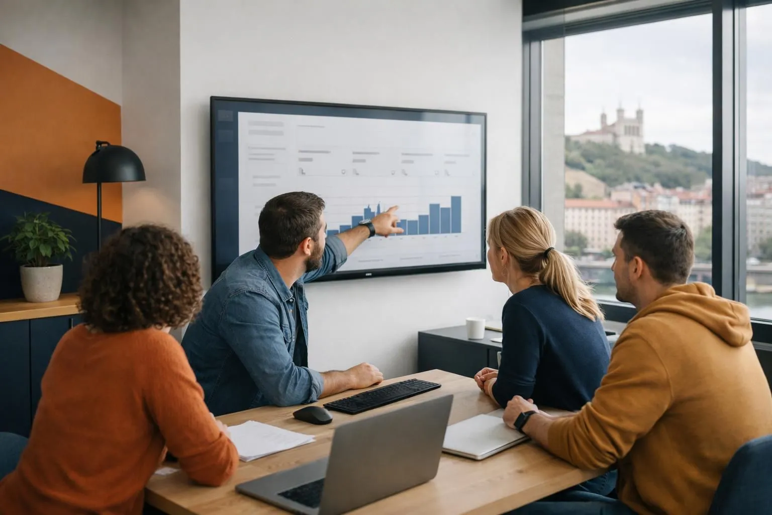 Professional web development team analyzing e-commerce dashboard on large monitor, Lyon modern office with WooCommerce interface visible, developer pointing at shopping cart metrics, collaborative workspace atmosphere, natural lighting