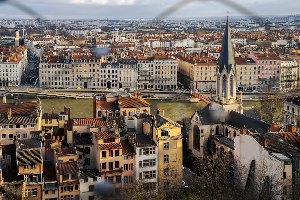 A view of a city through a fence
